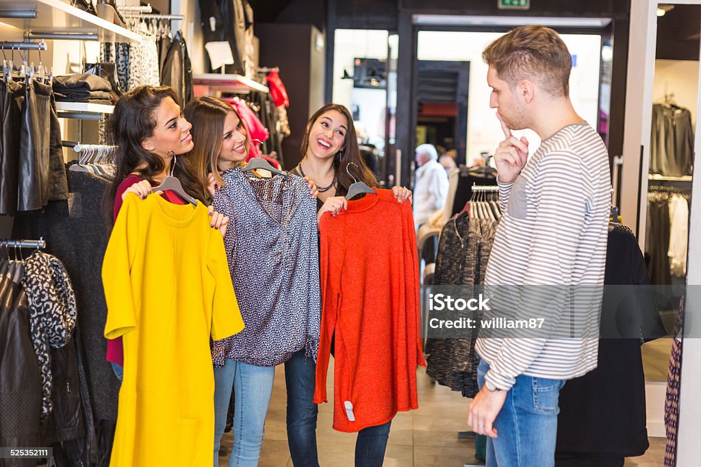 Man Helping Three Women Choosing New Clothes Adult Stock Photo