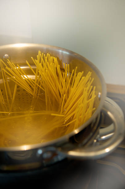 istock spaghetti pasta, boiled in the stock pot with colander 525352831