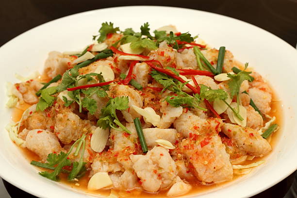 istock Spicy salad with  shrimp, fish and vegetables on white dish. 525353223