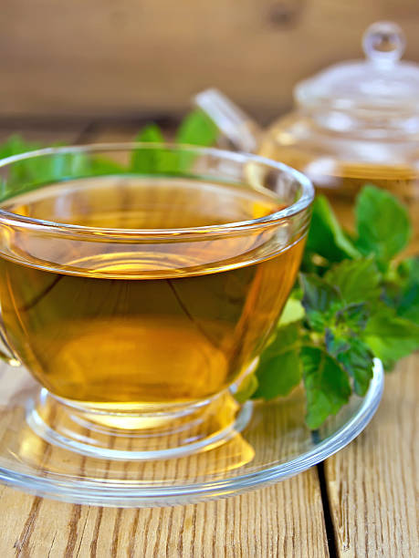 istock Tea with mint and teapot on wooden board 525353453