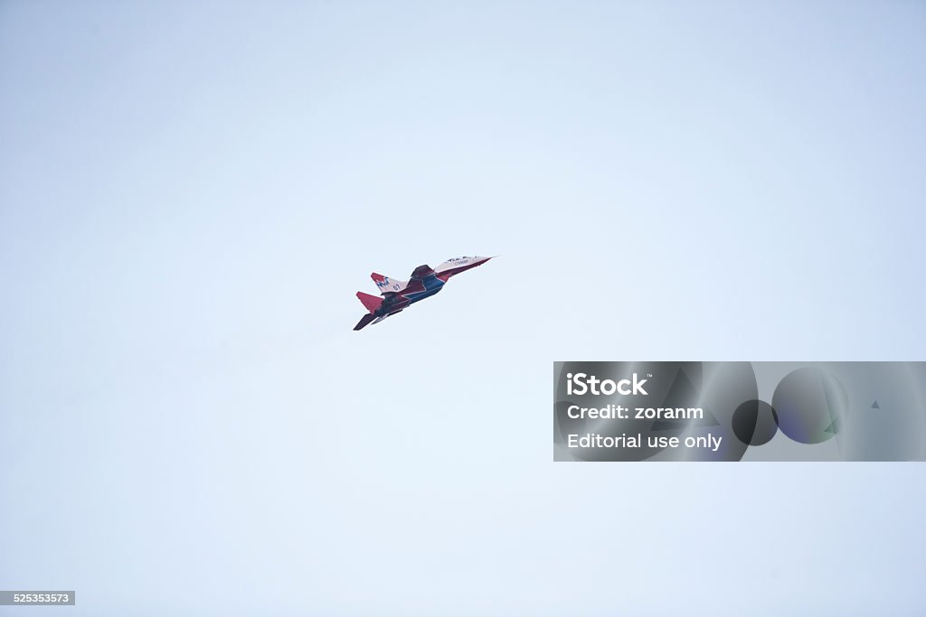 Aerobatics Belgrade, Serbia - October 16, 2014: Russian aerobatic MIG 29 airplane, part of the Swifts (Strizhi) group flying during a military parade in Belgrade. Russian President Vladimir Putin attended the parade which marked 70th anniversary of Belgrade's liberation from Nazi occupation. More than 3,000 soldiers took part in the military parade. 70th Anniversary Stock Photo