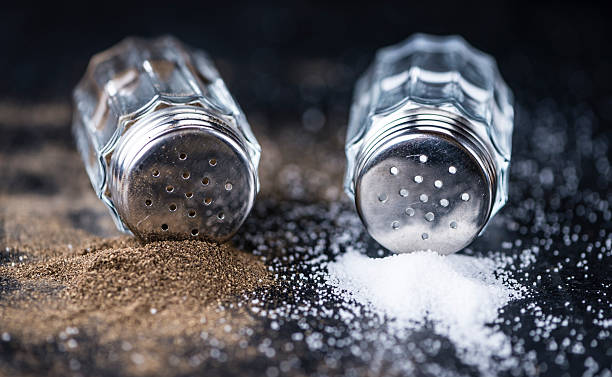 Salt and Pepper Shakers on a slate slab Salt and Pepper Shakers on a slate slab (selective focus; close-up shot) pepper shaker stock pictures, royalty-free photos & images