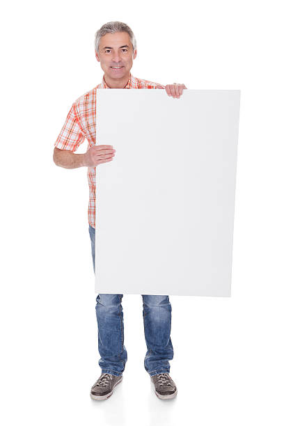 istock Happy Mature Man Holding Blank Placard 525355939