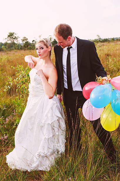 istock Funny wedding couple with balloons 525357131