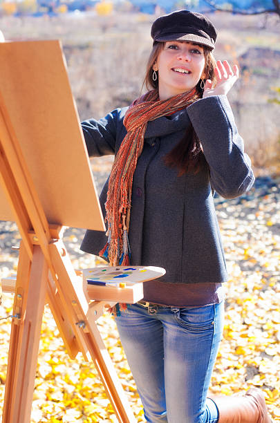 istock Woman having fun laughing near easel 525357351