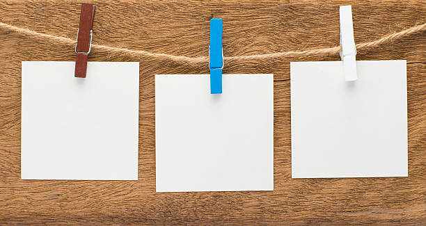 istock paper clothes peg on a wooden background 525363052