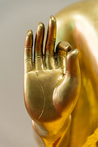 Buddha peace sign hand closeup
