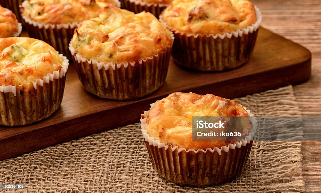 Homemade muffins with chicken and cheese on brown wooden board. Muffin Stock Photo