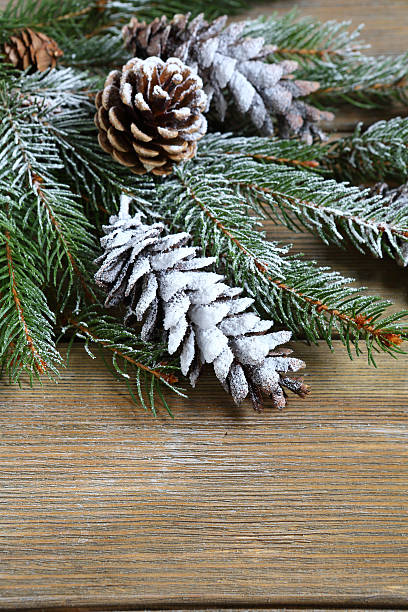istock Christmas fir branch covered with artificial snow on boards 525364257