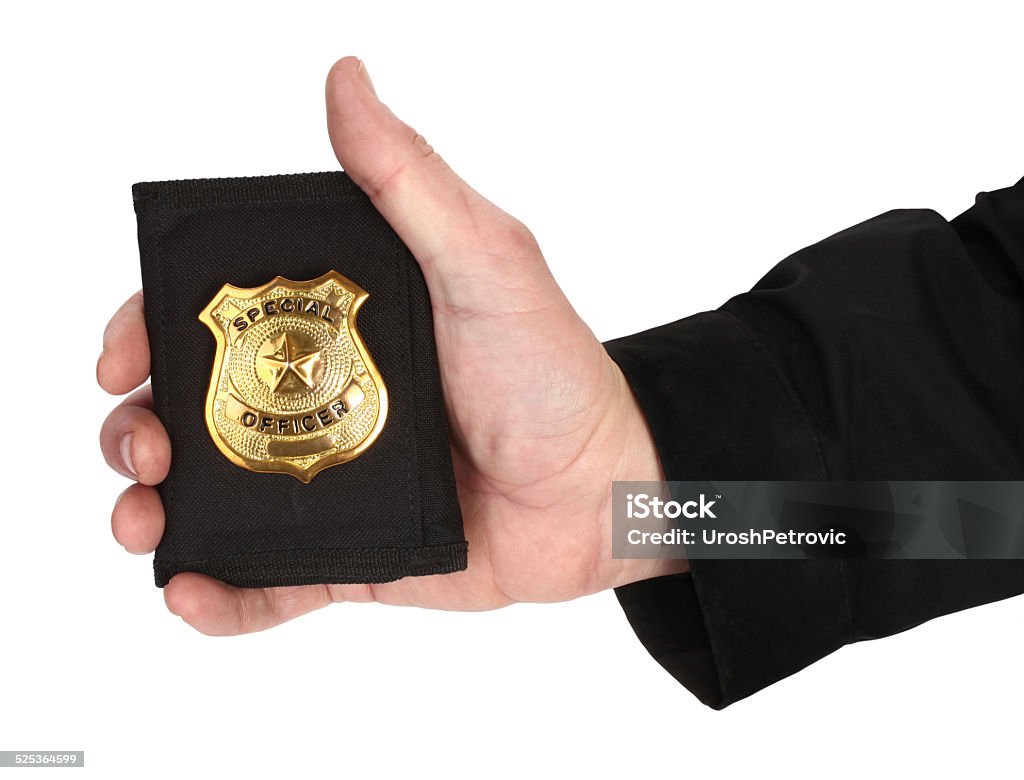 Man hand is holding golden special officer badge Here is man's hand, holding golden special officer badge. Police Badge Stock Photo