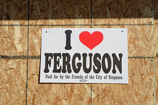 Ferguson, MO, USA – November 25, 2014: Sign on boarded up window in Ferguson as business owners show support for city in the aftermath of riots following announcement of Grand Jury clearing officer Darren Wilson of criminal charges in the shooting death of unarmed teen Michael Brown.