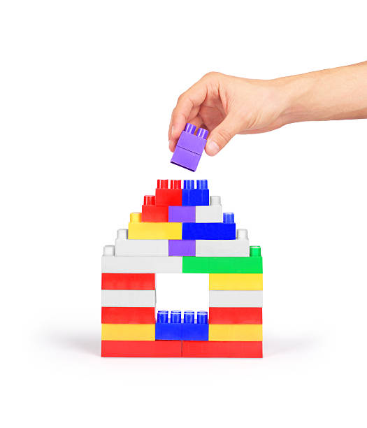 istock Hand building a house of blocks 525367044