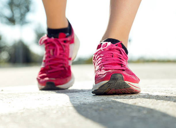 istock Runner feet running on road closeup on shoe. 525367189