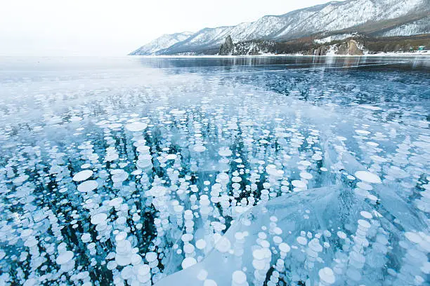 Bubbles of methane gas frozen into clear ice in Baikal lake