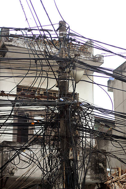 Chaos cables connection Chaos cables connection in the streets of Vietnam. They are electricity cables, internet cables, TV cables, telephone cables. complexity messy chaos house stock pictures, royalty-free photos & images