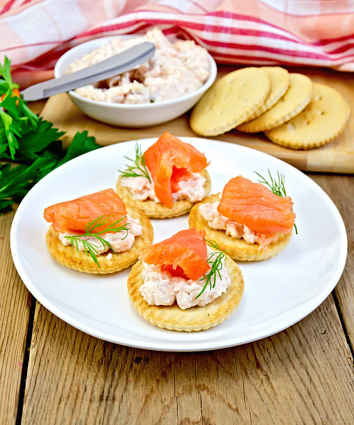 istock Crackers with cream and salmon in plate on board 525368193