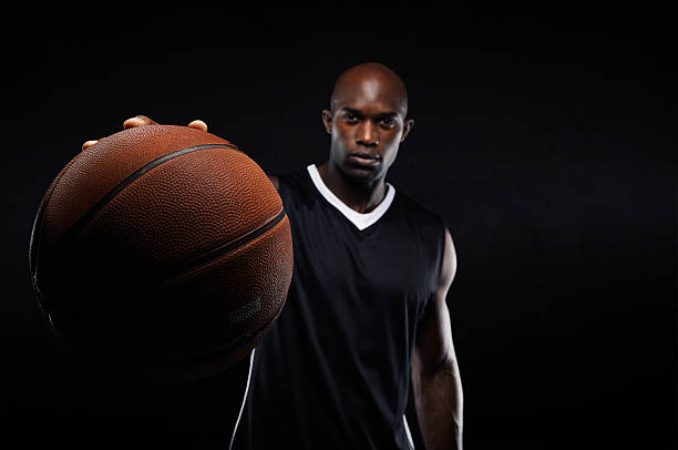 istock Young man holding a basketball 525368587