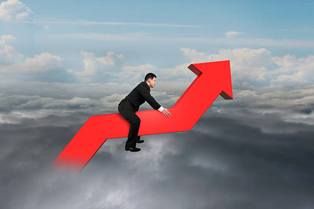 istock Businessman driving 3D red trend line in the sky 525380357