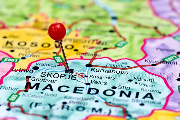 Photo of pinned Skopje on a map of europe. May be used as illustration for traveling theme.