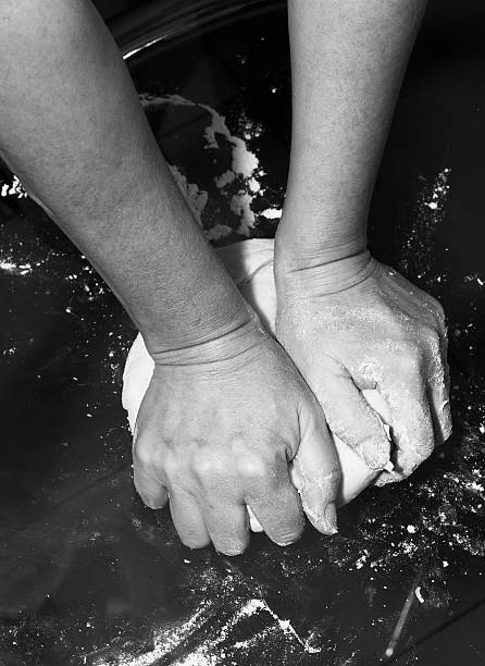 Hands kneading a dough.