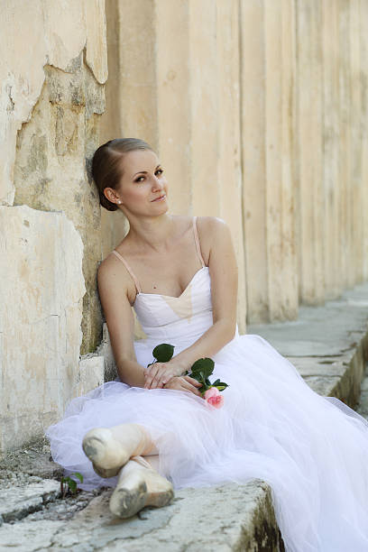 istock Beautiful ballerina in ancient colonnade 525383119