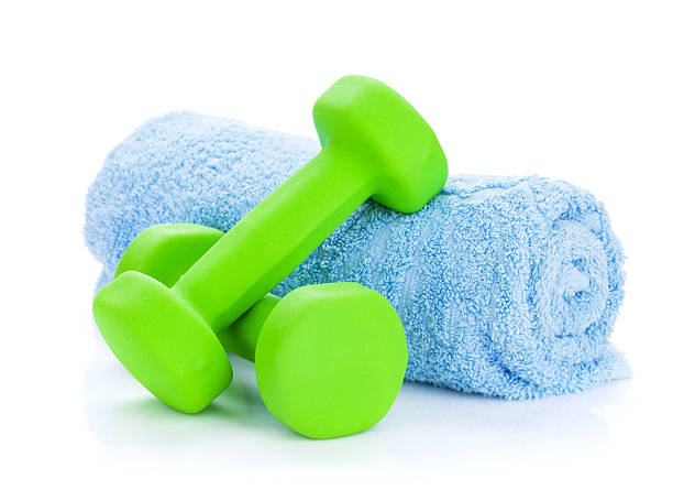 istock Two green dumbells and towel 525383315