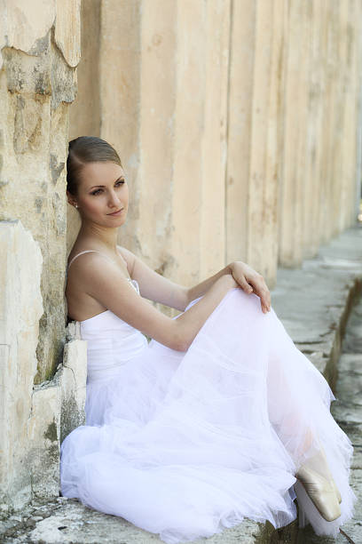 istock Beautiful ballerina in ancient colonnade 525384327