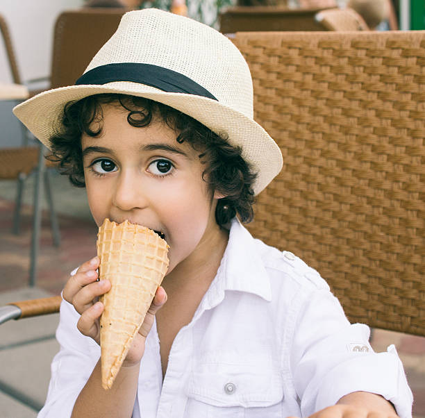 istock Cute little Boy Eating Ice-Cream 525384657