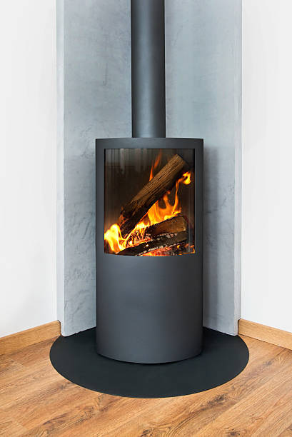 istock Modern burning stove in a corner of room 525385473