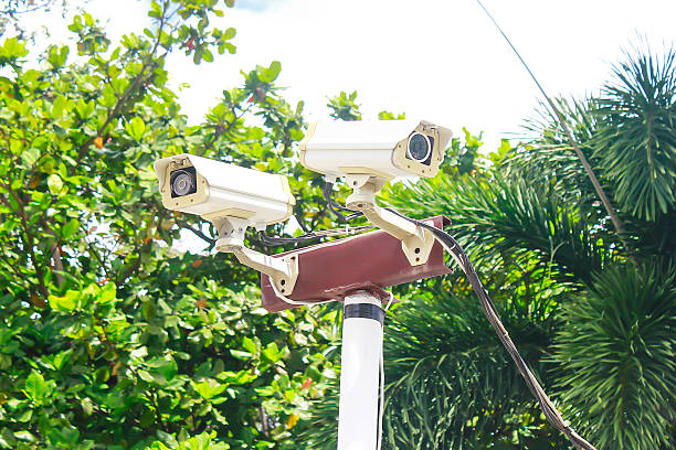 security camera and urban video security camera and urban video shooting guard stock pictures, royalty-free photos & images