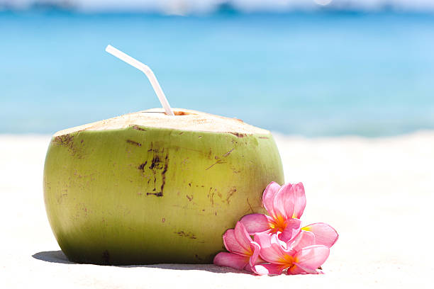 istock Tropical fresh cocktail on white beach 525386289