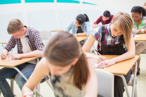 istock Students writing their GCSE exam in classroom 525409705