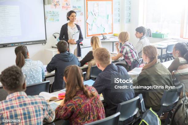 Teacher And Students In Classroom During Lesson Stock Photo - Download Image Now - Classroom, High School, Teacher
