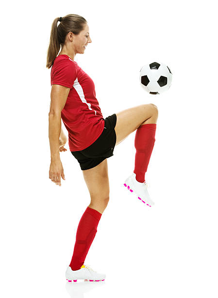 istock Smiling female soccer player juggling with ball 525419487