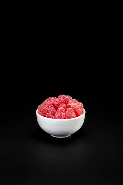istock Bowl with heart candy on black. 525430635