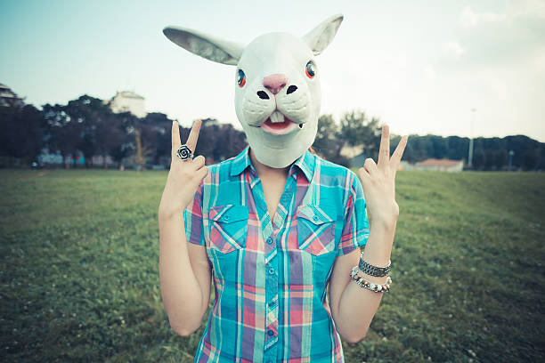 istock rabbit mask absurd beautiful young hipster woman 525432293