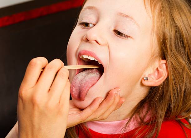 istock Examining Painful Throat 525433295