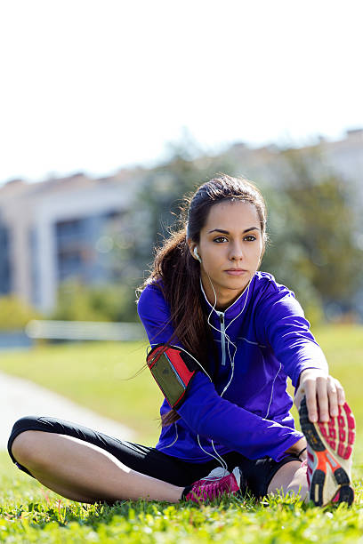 istock Young woman stretching and preparing for running 525434383
