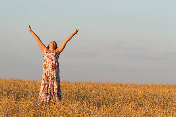 istock The girl is dancing in oat field. 525435081