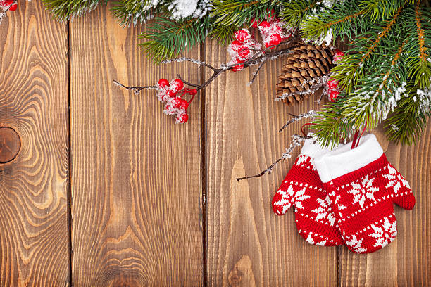 istock Christmas wooden background with snow fir tree and decor 525435537