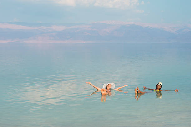 istock Floating in Dead Sea with friend. 525436087