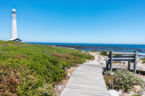 Slangkop Lighthouse in the Cape of good Hope, with a bench facing the sea. Seen along the road leading to African most southern tip