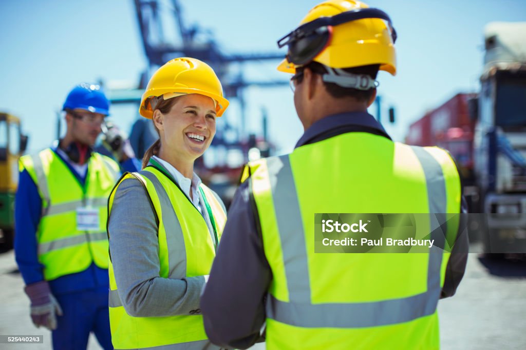 Business people wearing protective workwear talking  25-29 Years Stock Photo