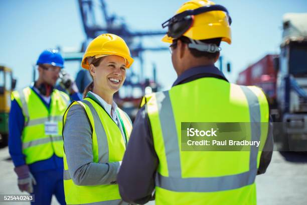 Business People Wearing Protective Workwear Talking Stock Photo - Download Image Now
