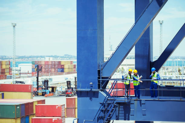 Dockworker giving instructions and writing  