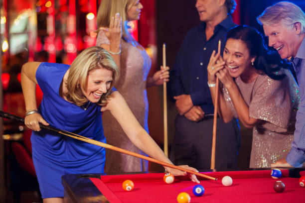 istock Friends playing pool in nightclub 525441225