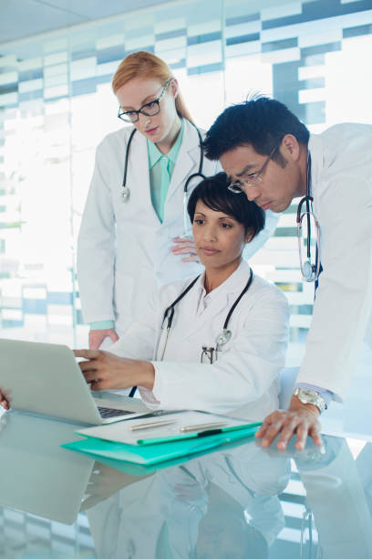 istock Doctors using laptop and discussing patients treatment 525441287