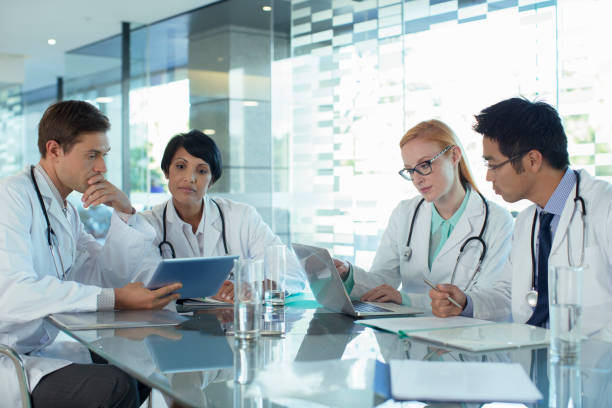 istock Doctors using laptop and discussing patients treatment 525441365