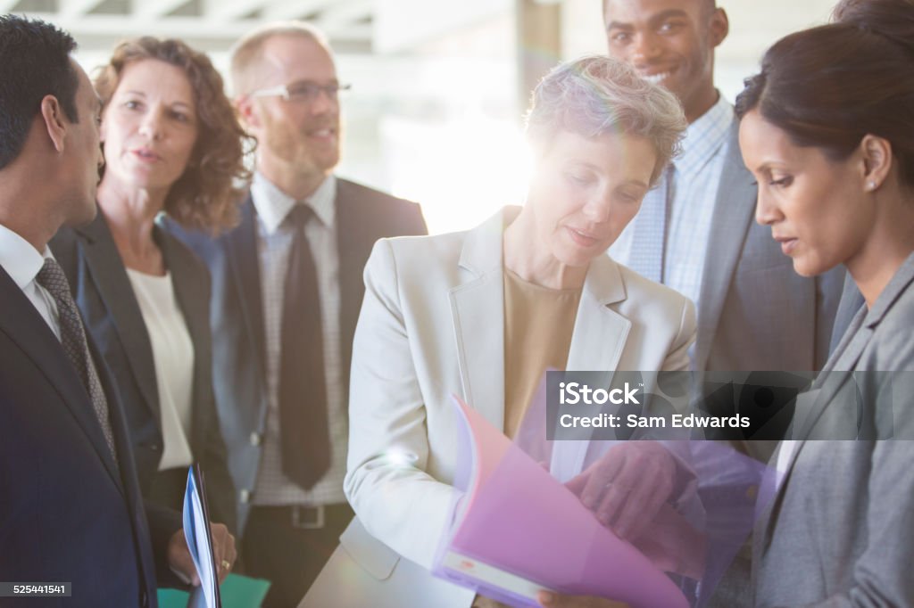 Office team sharing documents at meeting  25-29 Years Stock Photo