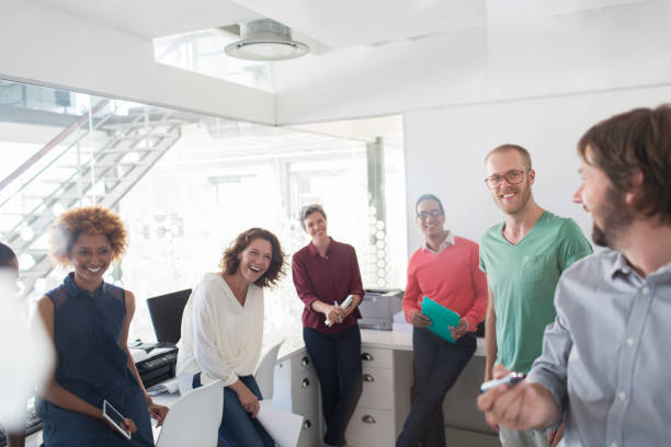 istock Smiling team having meeting in modern office 525441607